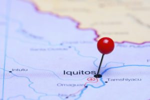 Photo of pinned Iquitos on a map of South America. May be used as illustration for traveling theme.