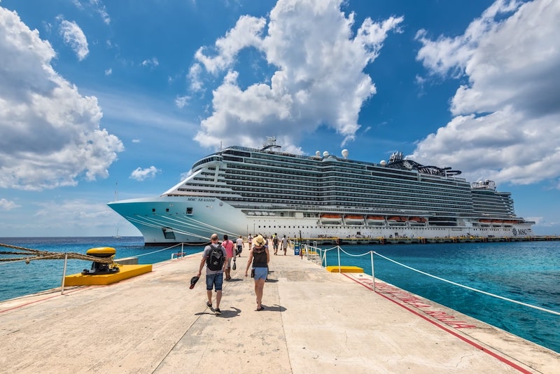 People Walking Towards A Cruise Ship