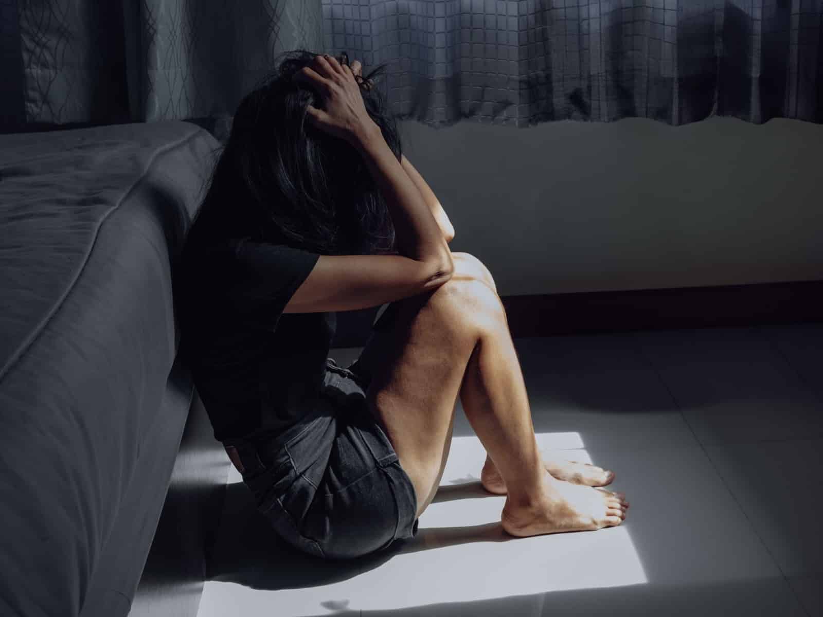 Woman sitting by the bed