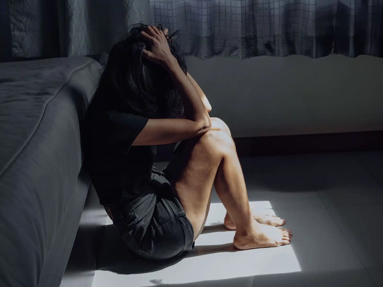 Woman sitting by the bed