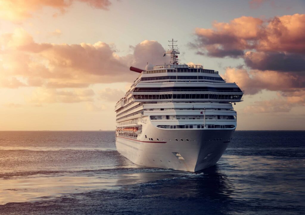Luxury cruise ship leaving port at sunset